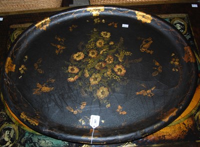 Lot 967 - A large oval lacquered tray with gilt details...