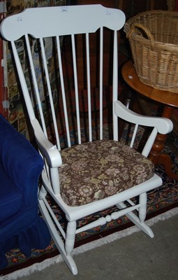 Lot 1018 - A white painted spindle back rocking chair.