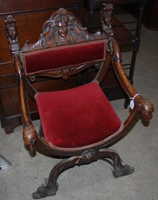Lot 989 - An antique fruit wood X-frame armchair with...