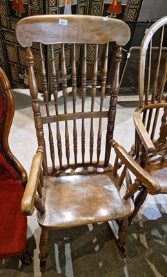 Lot 1017 - A spindle back rocking chair.