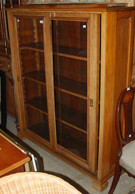 Lot 1002 - An early 20th century oak bookcase with two...