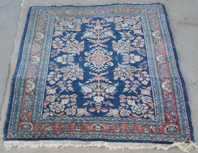 Lot 1064 - A small Persian mat with foliate design,...