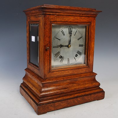 Lot 305 - A 19th century oak library clock, the top and...