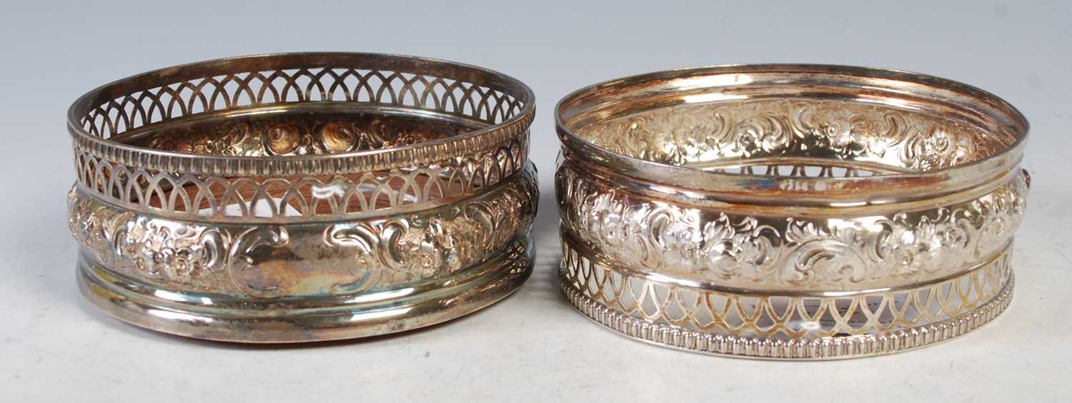 Lot 121 - A pair of George III silver bottle stands,...