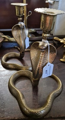 Lot 417 - A pair of Indian brass candlesticks in the...