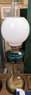 Lot 282 - A 20th century oil lamp with opaque glass...