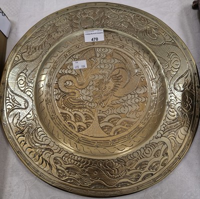 Lot 470 - A Chinese brass charger with incised details...