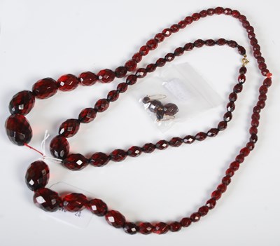 Lot 107 - Two vintage red amber type bead necklaces of...