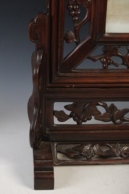 Lot 187 - A Chinese porcelain and dark wood table screen,...