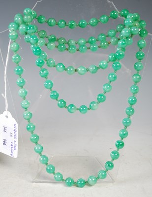 Lot 35 - A long green jade bead necklace, together with...