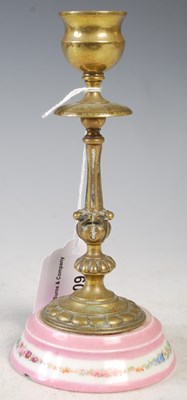 Lot 209 - A brass and porcelain mounted candlestick,...