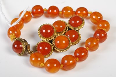 Lot 50 - A vintage amber bead bracelet with gilt metal...