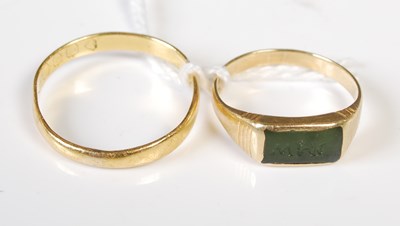 Lot 56 - Two high carat yellow metal rings, one with...