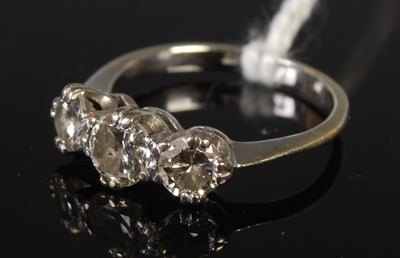 Lot 69 - A white metal and diamond three stone ring,...