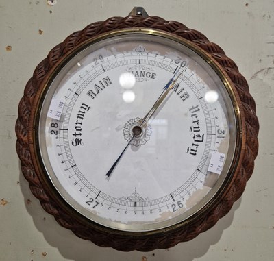 Lot 635 - An antique oak cased circular form barometer...