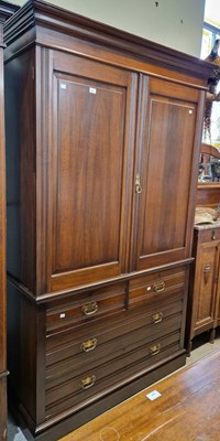 Lot 644 - An antique mahogany linen press in two parts,...