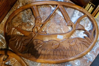 Lot 648 - Two teak carved wooden wall plaques, one in...