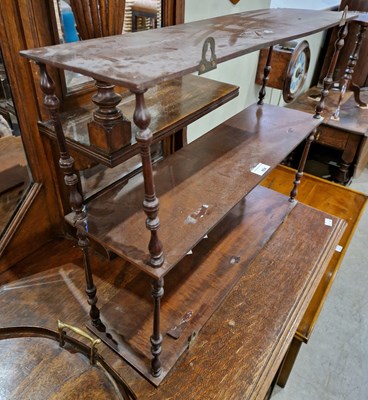 Lot 654 - A 20th century mahogany three-tier hanging shelf.