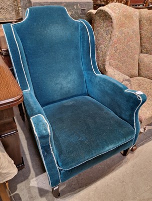 Lot 669 - An antique wingback armchair with blue / green...