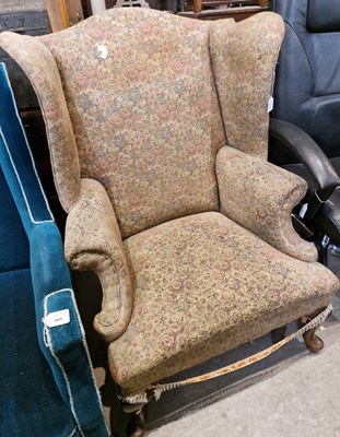 Lot 670 - An antique wingback armchair with floral...