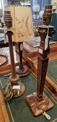 Lot 682 - Three assorted antique wooden table lamps.