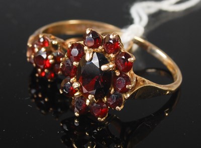Lot 79 - Two 9ct gold and garnet flower cluster rings,...