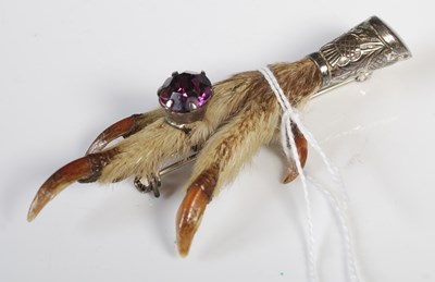 Lot 282 - A vintage white metal mounted claw brooch.