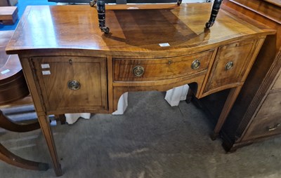 Lot 695 - A George III style mahogany bowfront sideboard...