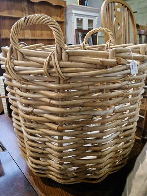 Lot 705 - A large wicker twin handled log basket.