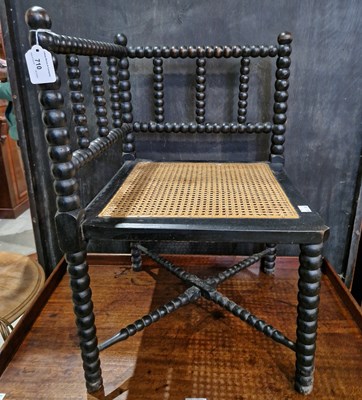 Lot 710 - A 19th century ebonised bobbin turned corner...