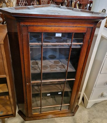 Lot 718 - An antique mahogany hanging corner cupboard...