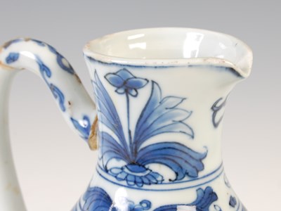 Lot 557 - A Chinese porcelain blue and white jug, Qing...