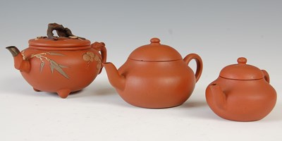 Lot 562 - Three Chinese Yixing tea pots and covers, the...