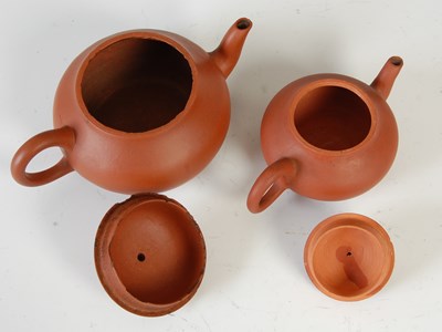 Lot 562 - Three Chinese Yixing tea pots and covers, the...
