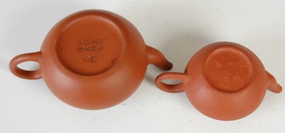 Lot 562 - Three Chinese Yixing tea pots and covers, the...