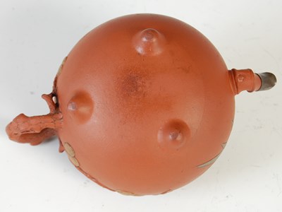 Lot 562 - Three Chinese Yixing tea pots and covers, the...
