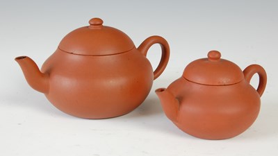Lot 562 - Three Chinese Yixing tea pots and covers, the...