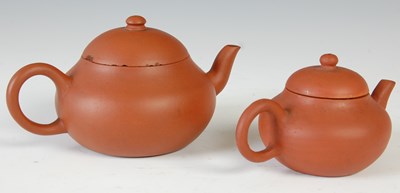 Lot 562 - Three Chinese Yixing tea pots and covers, the...