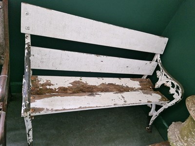 Lot 768 - An antique white painted cast metal garden bench.