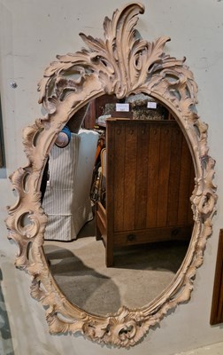 Lot 547 - A composite Rococo style oval wall mirror with...