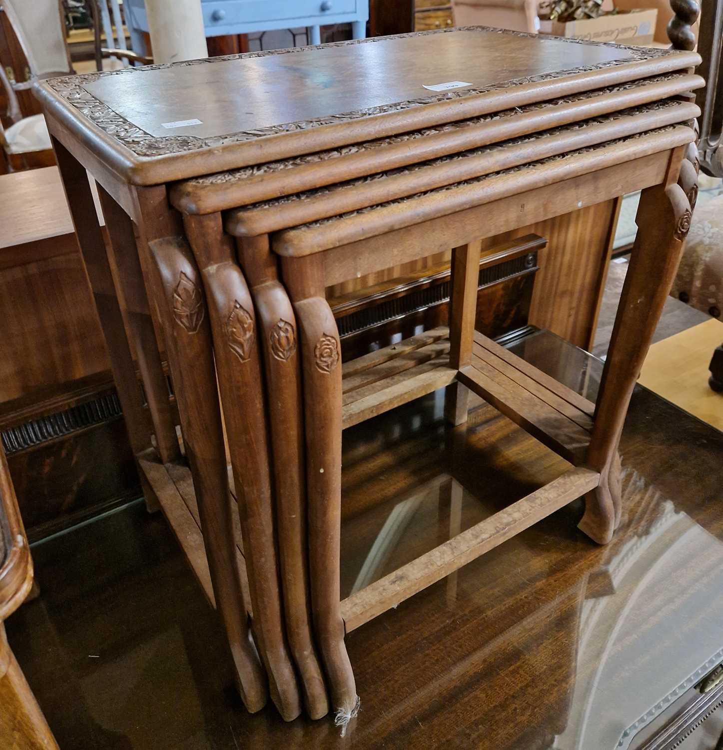 Lot 799 - A nest of four Indian occasional tables with...