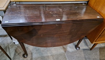 Lot 812 - A 19th century mahogany drop-leaf table raised...