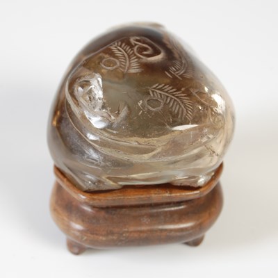 Lot 579 - A Chinese rock crystal carving of a Shishi dog,...