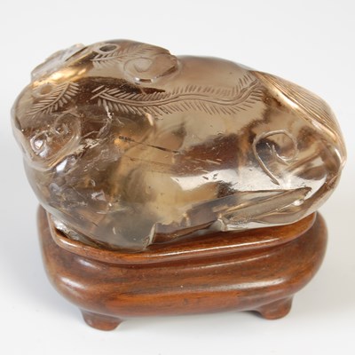 Lot 579 - A Chinese rock crystal carving of a Shishi dog,...
