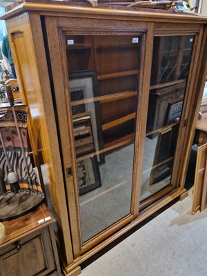 Lot 587 - An early 20th century oak bookcase with two...