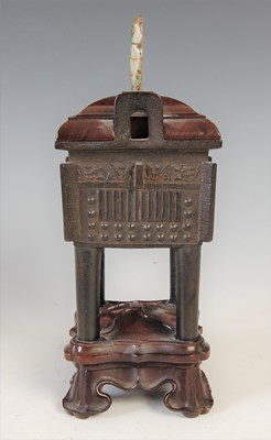 Lot 583 - A Chinese bronze archaic style Ding and wood...