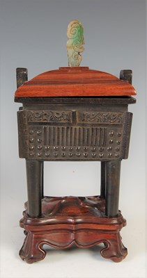 Lot 583 - A Chinese bronze archaic style Ding and wood...