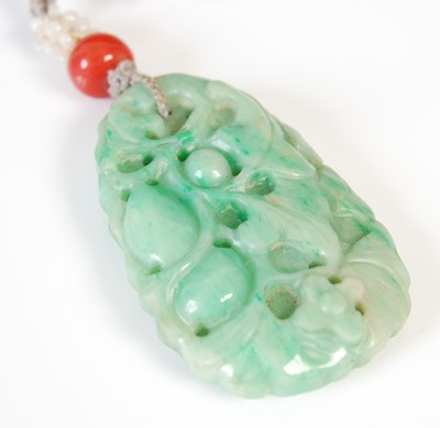 Lot 590 - Two antique Chinese carved stone pendants,...