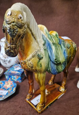 Lot 21 - A Chinese pottery model of a horse, decorated...