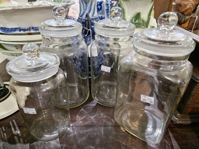 Lot 367 - Four assorted glass storage jars and covers,...